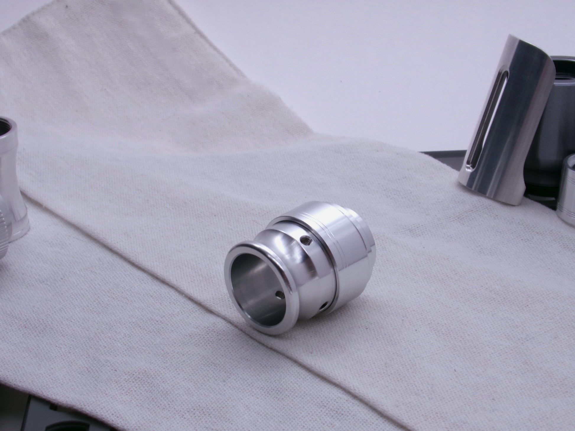 An aluminum VHC compatible emitter tip, completes a mockup shown 3/4 view on a coarse cloth.