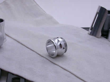An emitter tip, 3/4 view resting on a coarse cloth.