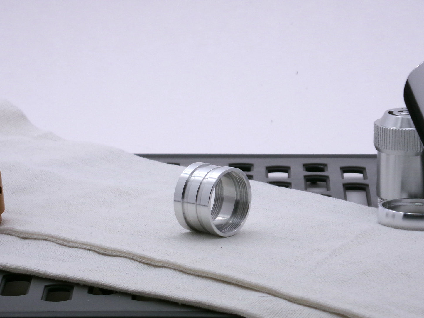 Aluminum female/female threaded ribbed extension for VHC lightsabers; three-quarter view.
