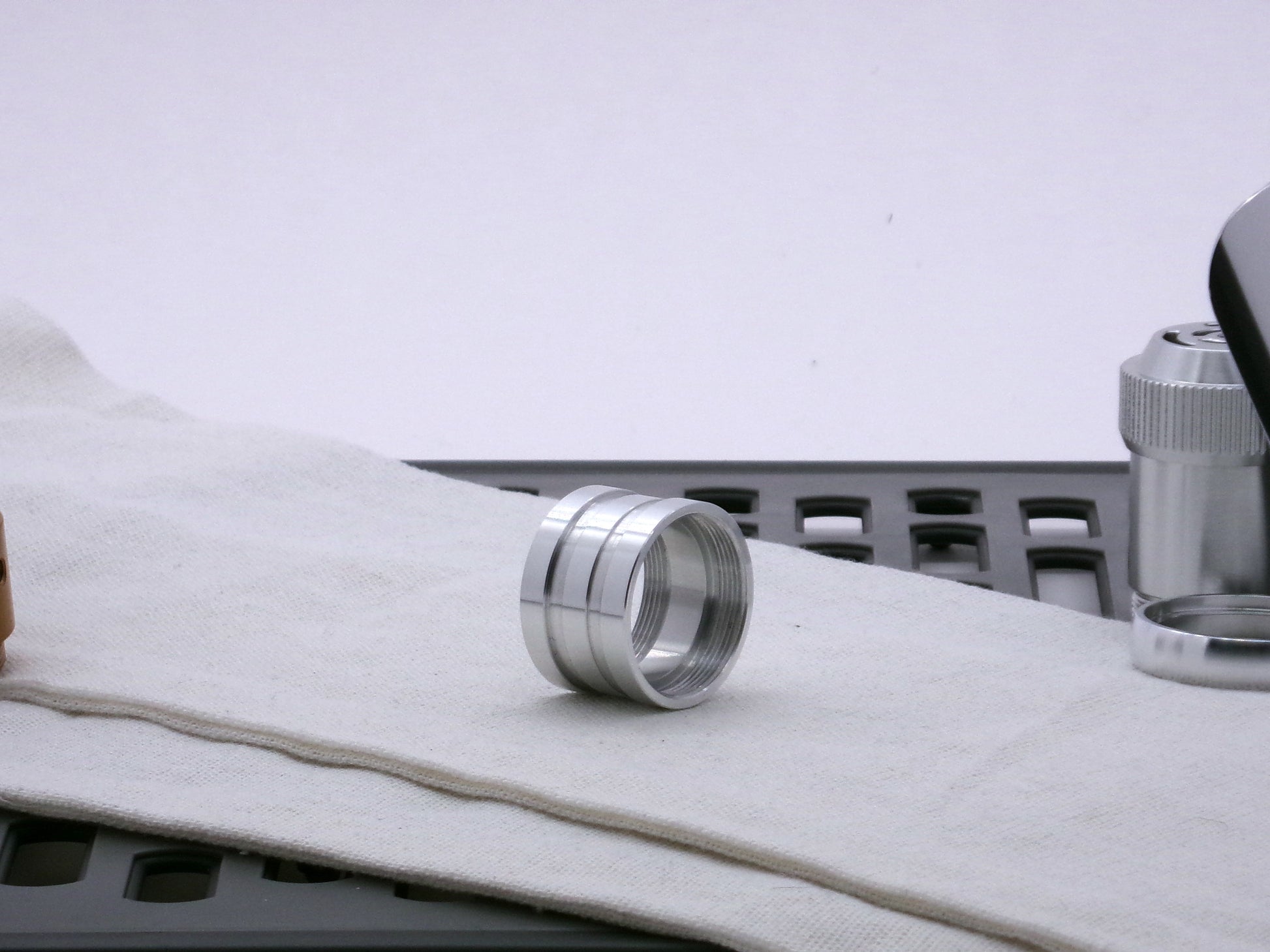 Aluminum female/female threaded ribbed extension for VHC lightsabers; three-quarter view.