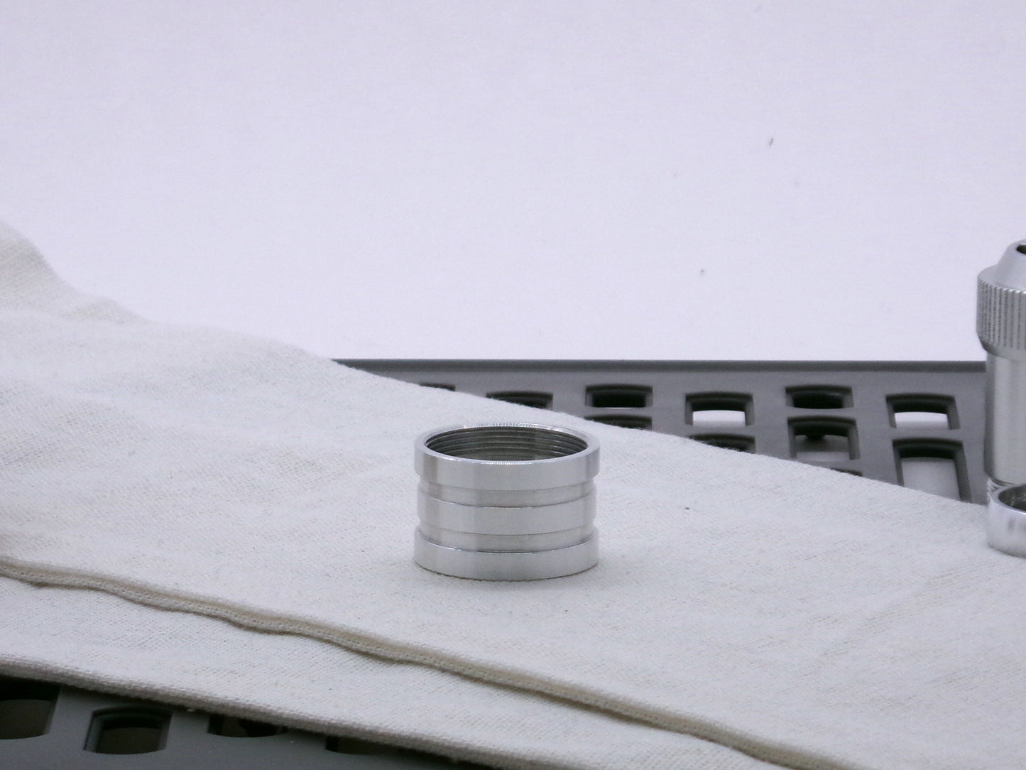 Aluminum female/female threaded ribbed extension for VHC lightsabers; standing proud.