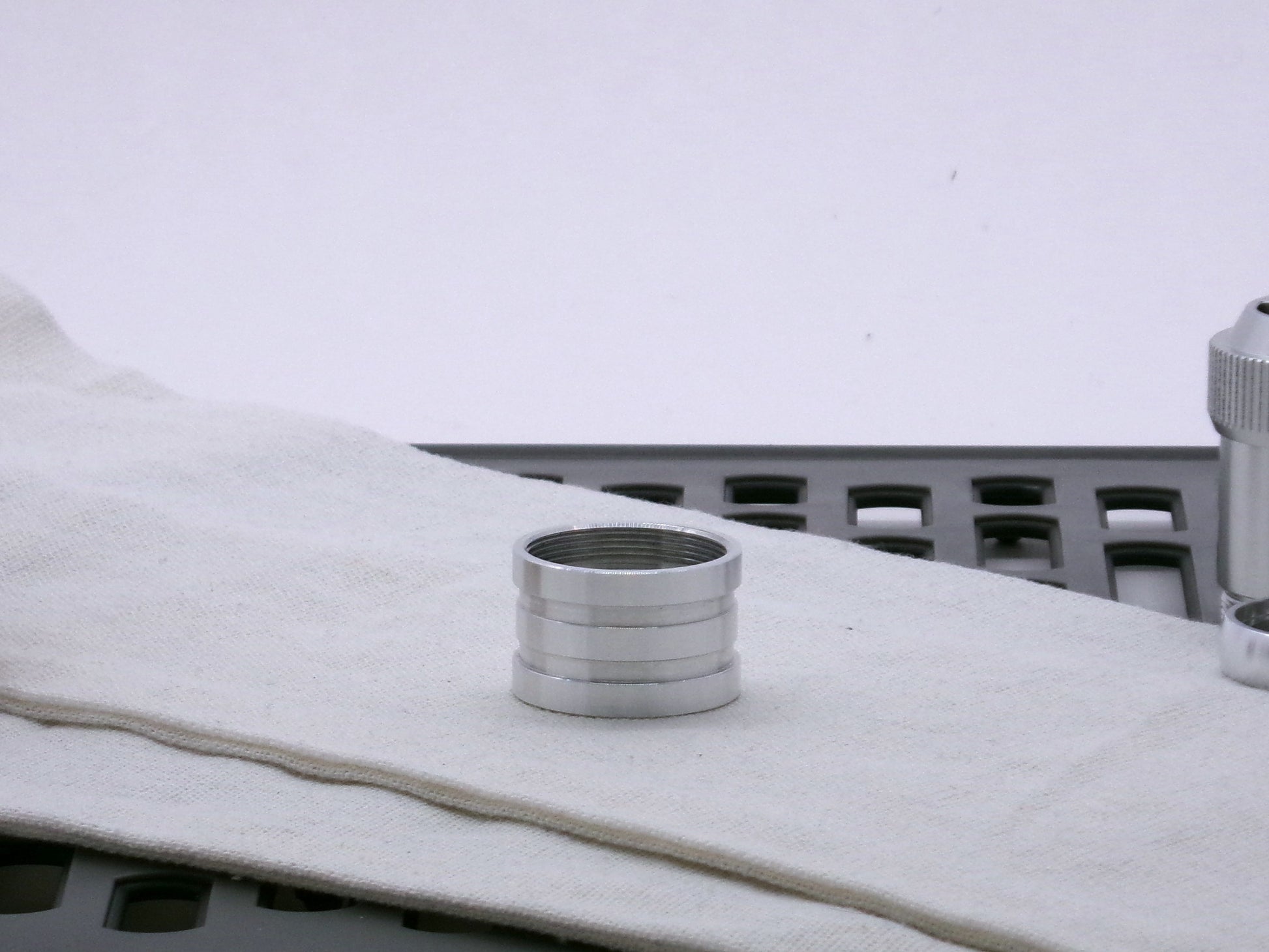 Aluminum female/female threaded ribbed extension for VHC lightsabers; standing proud.