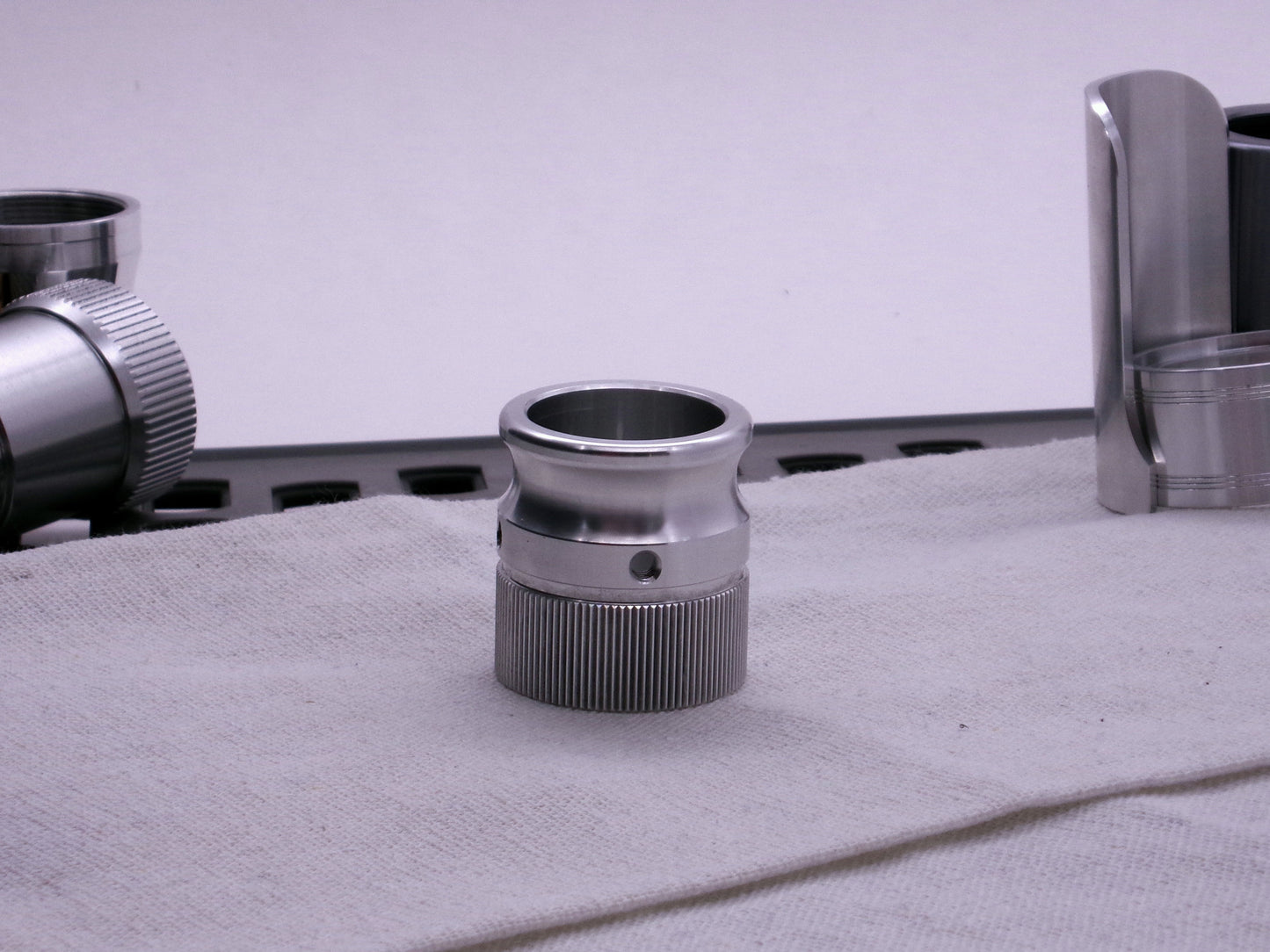 VHC compatible knurled body segment threaded on to an emitter tip sitting flat on cloth