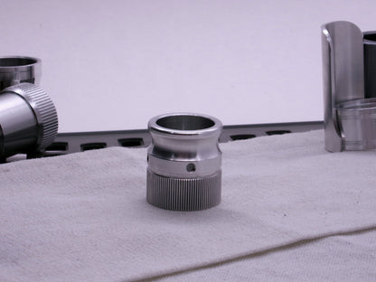 VHC compatible knurled body segment threaded on to an emitter tip sitting flat on cloth