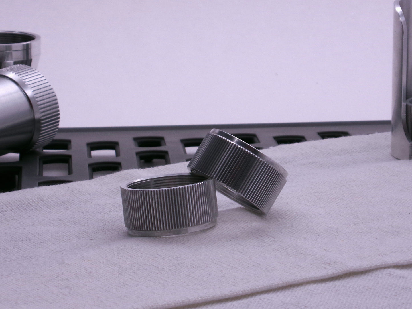 Pair of VHC compatible knurled body segments sitting askew on a cloth.