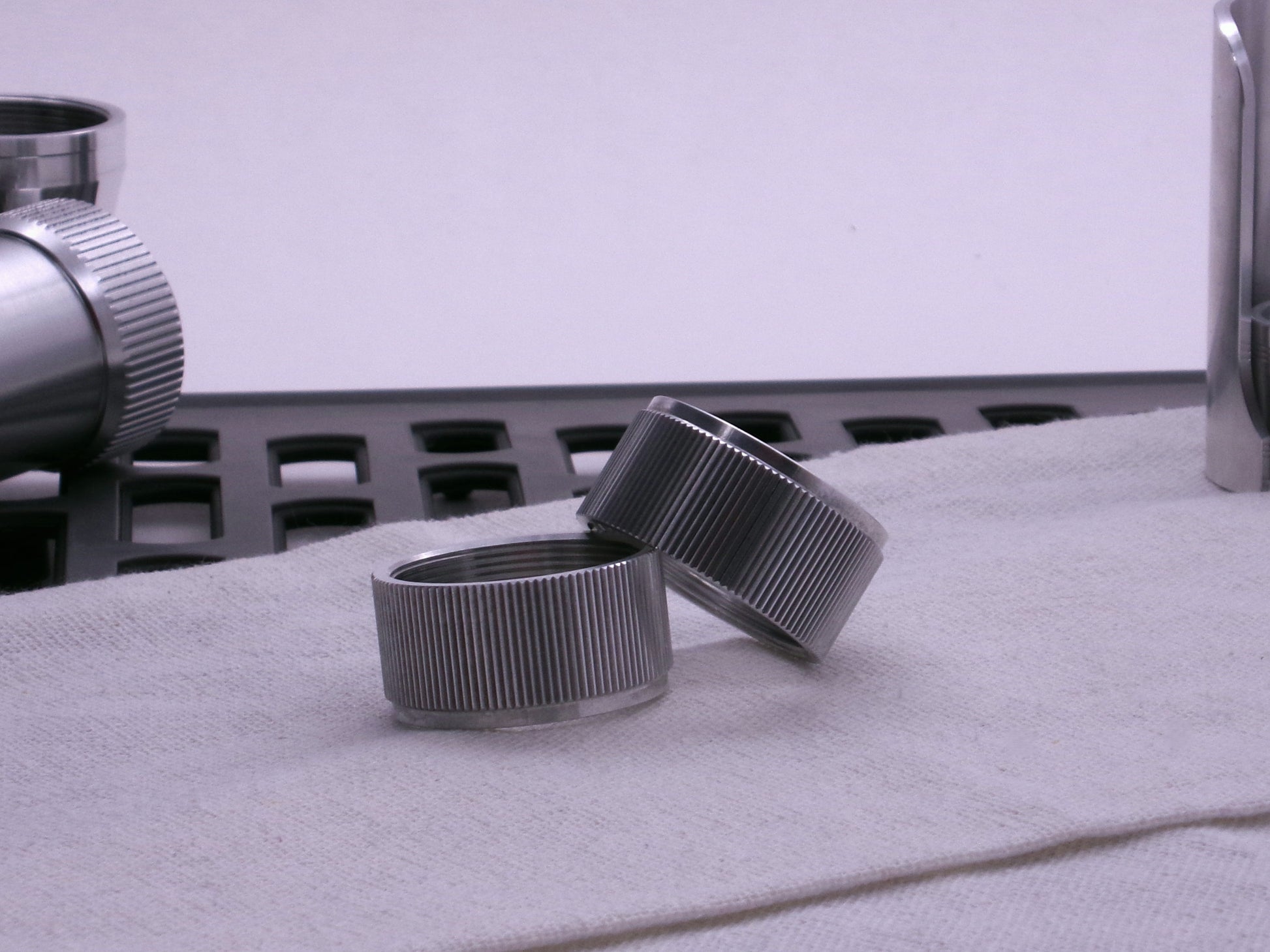 Pair of VHC compatible knurled body segments sitting askew on a cloth.