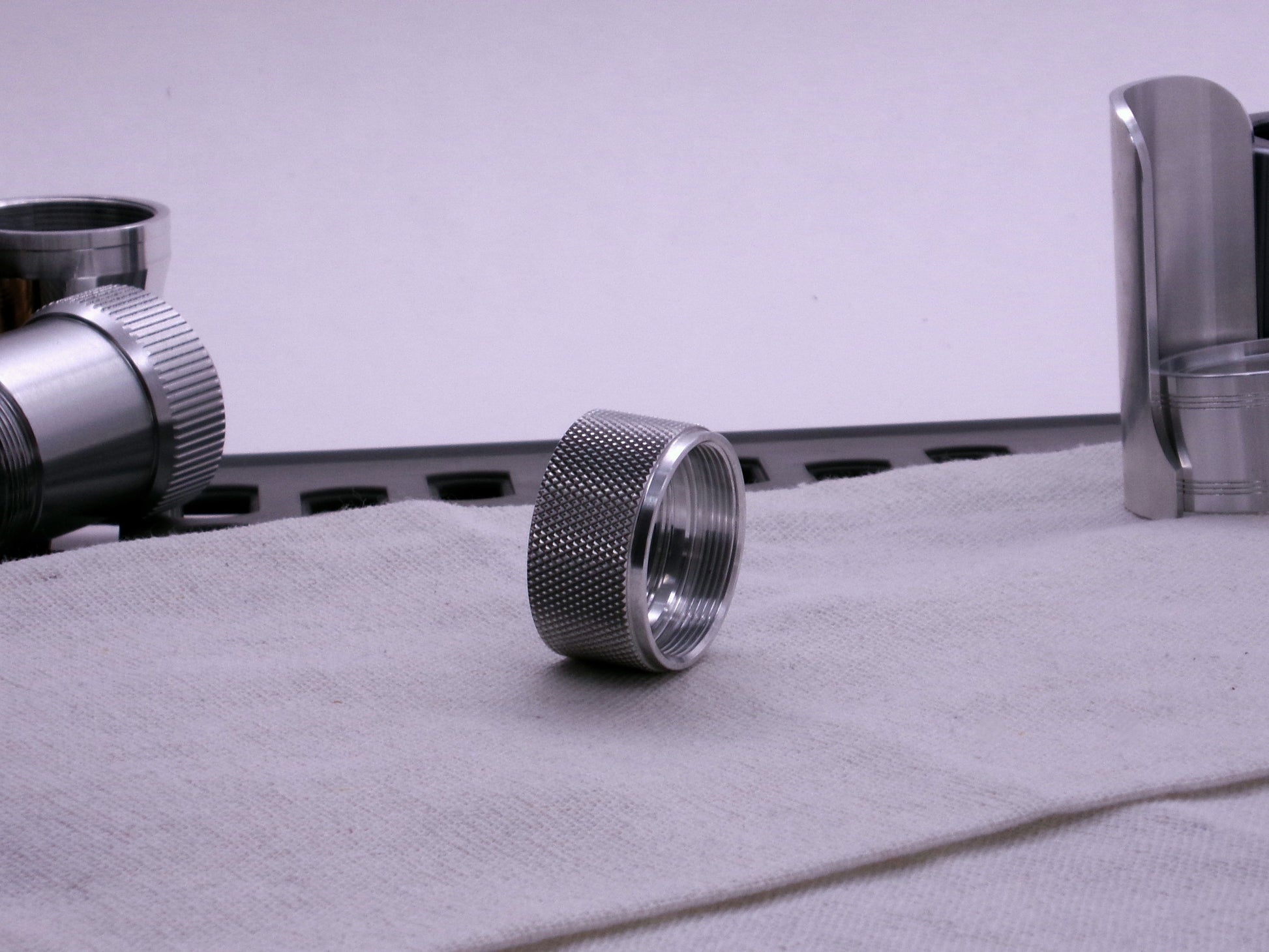 VHC compatible knurled body segment, 3/4 front view sitting on a cloth