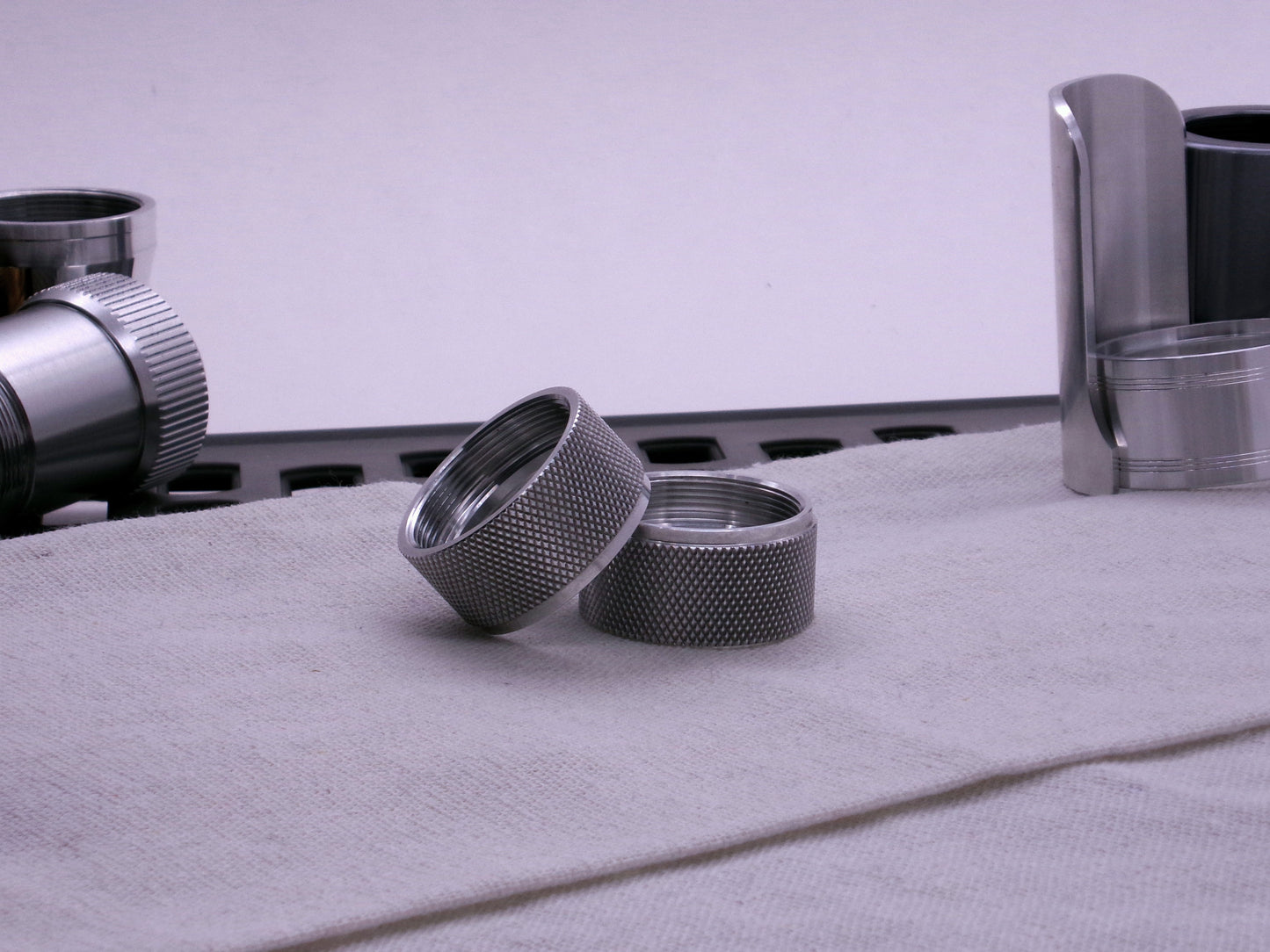 Pair of VHC compatible knurled body segments sitting askew on a cloth