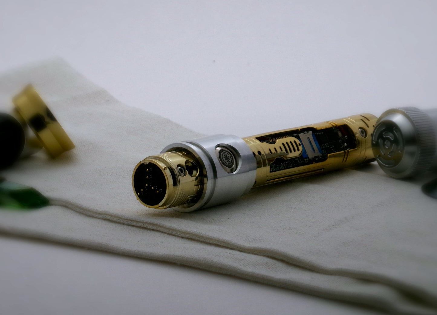 Aluminum female/female threaded switch section installed on a naked chassis VHC lightsaber chassis; three-quarter view left.