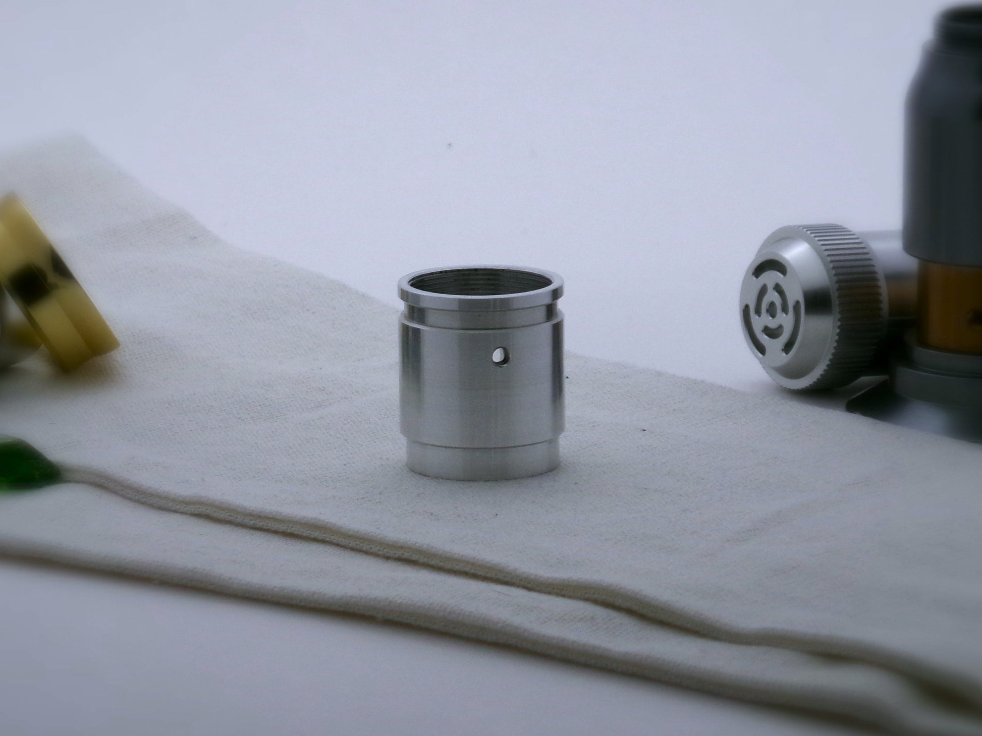 Aluminum female/female threaded switch section formatted for VHC lightsabers; standing proud, rear view.